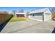 Long driveway with a detached garage and house in the background at 1716 Fulton St, Aurora, CO 80010