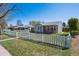 Quaint home with a welcoming front yard and classic white picket fence for added curb appeal at 1716 Fulton St, Aurora, CO 80010