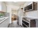 Modern kitchen features stainless steel appliances, light gray cabinets, and stylish backsplash at 1716 Fulton St, Aurora, CO 80010