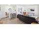 Open concept living space with bar seating, wood floors, and a comfortable seating area at 1716 Fulton St, Aurora, CO 80010
