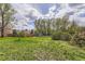 Spacious backyard featuring lush green grass, mature trees, and a wood fence, perfect for outdoor activities at 4707 Ashfield Ct, Boulder, CO 80301