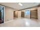 A finished basement with built-in shelving along the wall and neutral colors at 4707 Ashfield Ct, Boulder, CO 80301