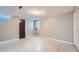 A large basement room with neutral walls and flooring, plus a window and a dark-stained door at 4707 Ashfield Ct, Boulder, CO 80301