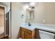 A cozy bathroom featuring tiled accents, wood cabinetry, and a shower with glass doors at 4707 Ashfield Ct, Boulder, CO 80301