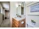 Cozy bathroom with vanity, wood cabinet, modern lighting, and large framed mirror at 4707 Ashfield Ct, Boulder, CO 80301