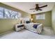 Bedroom with a ceiling fan, soft carpet, a large window, and neutral-toned decor at 4707 Ashfield Ct, Boulder, CO 80301