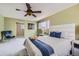 Bedroom with a ceiling fan, soft carpet, a large window, and soft, neutral-toned decor at 4707 Ashfield Ct, Boulder, CO 80301
