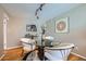 Dining room with modern glass-top table and stylish seating, illuminated by track lighting at 4707 Ashfield Ct, Boulder, CO 80301