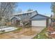 Blue two-story home with brick accents and snow dusting the yard and roof at 4707 Ashfield Ct, Boulder, CO 80301