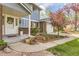 Inviting front porch with seasonal foliage and brick and siding exterior details at 4707 Ashfield Ct, Boulder, CO 80301