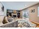 Cozy living room with brick fireplace, built-in shelves, and sliding glass doors to the patio at 4707 Ashfield Ct, Boulder, CO 80301