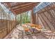 Shaded patio with a lattice cover, brick flooring, and a picnic table next to a brick wall at 4707 Ashfield Ct, Boulder, CO 80301