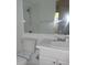 A compact bathroom features a large mirror and vanity storage at 6705 S Field St # 802, Littleton, CO 80128