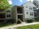 Inviting condo building featuring stone accents, a covered entry, and multiple levels of comfortable living at 6705 S Field St # 802, Littleton, CO 80128