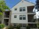 Exterior of a condo building, featuring a covered entryway, private balconies, and classic architectural details at 6705 S Field St # 802, Littleton, CO 80128