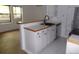 Open kitchen featuring stylish countertops, white cabinets, and seamless access to the living area at 6705 S Field St # 802, Littleton, CO 80128