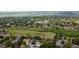 Panoramic aerial view of a suburban neighborhood surrounded by lush greenery and mountain views at 13249 W Jewell Pl, Denver, CO 80228