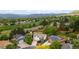 Scenic aerial view of a neighborhood showcasing lush greenery, diverse architecture, and mountain views at 13249 W Jewell Pl, Denver, CO 80228