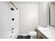 Updated bathroom with a white tiled shower-tub, modern vanity, and black hardware at 13249 W Jewell Pl, Denver, CO 80228