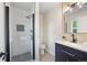 This stylish bathroom boasts a modern vanity, decorative mirror and sleek glass enclosed shower at 13249 W Jewell Pl, Denver, CO 80228