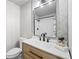 Modern bathroom featuring stylish vanity, decorative mirror and patterned tile backsplash at 13249 W Jewell Pl, Denver, CO 80228