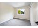 Neutral toned bedroom with window, closet and plush gray carpet at 13249 W Jewell Pl, Denver, CO 80228