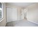 Carpeted bedroom with a closet and natural light from the window at 13249 W Jewell Pl, Denver, CO 80228