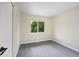 Neutral toned bedroom featuring plush gray carpet and a bright window at 13249 W Jewell Pl, Denver, CO 80228