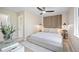 Serene bedroom with a minimalist design, wood accent wall, and natural lighting at 13249 W Jewell Pl, Denver, CO 80228