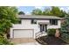 Charming two-story home featuring an attached garage and well-maintained landscaping at 13249 W Jewell Pl, Denver, CO 80228