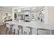 Bright kitchen featuring a large quartz countertop island with barstool seating at 13249 W Jewell Pl, Denver, CO 80228