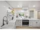 Open kitchen featuring stainless steel appliances and a quartz countertop island with oven range at 13249 W Jewell Pl, Denver, CO 80228