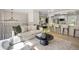 Open-concept living room with hardwood floors, a modern chandelier, and natural light at 13249 W Jewell Pl, Denver, CO 80228
