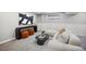 Bright living room with neutral tones, modern art, and comfortable seating area at 13249 W Jewell Pl, Denver, CO 80228