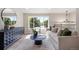 Bright open concept living room with a large window with stylish furniture and wood floors at 13249 W Jewell Pl, Denver, CO 80228