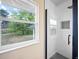 Modern tiled shower with black hardware and a view from the bathroom window at 13249 W Jewell Pl, Denver, CO 80228