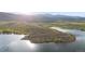 An aerial of a beautiful lake with a small island at 3900 Bogey Ct, Longmont, CO 80503