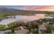 Beautiful aerial view of homes near a serene lake with mountains in the background at sunset at 3900 Bogey Ct, Longmont, CO 80503