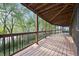 Spacious covered back porch offering scenic views of the surrounding trees at 3900 Bogey Ct, Longmont, CO 80503