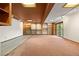 Spacious basement with neutral carpeting, shelving, and sliding glass doors at 3900 Bogey Ct, Longmont, CO 80503