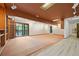 Large basement area with neutral carpeting, shelving, and access to the outdoors at 3900 Bogey Ct, Longmont, CO 80503