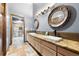 Spa bathroom featuring double sinks, stylish mirrors, and a glass-enclosed shower at 3900 Bogey Ct, Longmont, CO 80503