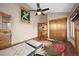 Stylish bedroom featuring a ceiling fan, wood floors, and a unique area rug at 3900 Bogey Ct, Longmont, CO 80503