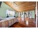 Spacious bedroom with natural light, wood floors, and custom shelving for ample storage at 3900 Bogey Ct, Longmont, CO 80503