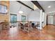 Charming dining area with rustic table, terra cotta tile, and an inviting ambiance at 3900 Bogey Ct, Longmont, CO 80503