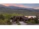 Exterior of a beautiful brown home with mountain views surrounded by lush greenery near the lake at 3900 Bogey Ct, Longmont, CO 80503