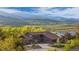 Exterior of a beautiful home with mountain and lake views surrounded by lush greenery at 3900 Bogey Ct, Longmont, CO 80503
