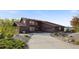 Expansive home featuring a long driveway and desert landscaping at 3900 Bogey Ct, Longmont, CO 80503
