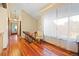 Hallway features wood floors, natural light, and a view of the bedroom at 3900 Bogey Ct, Longmont, CO 80503