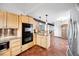 Open kitchen featuring granite countertops and wood cabinets at 3900 Bogey Ct, Longmont, CO 80503